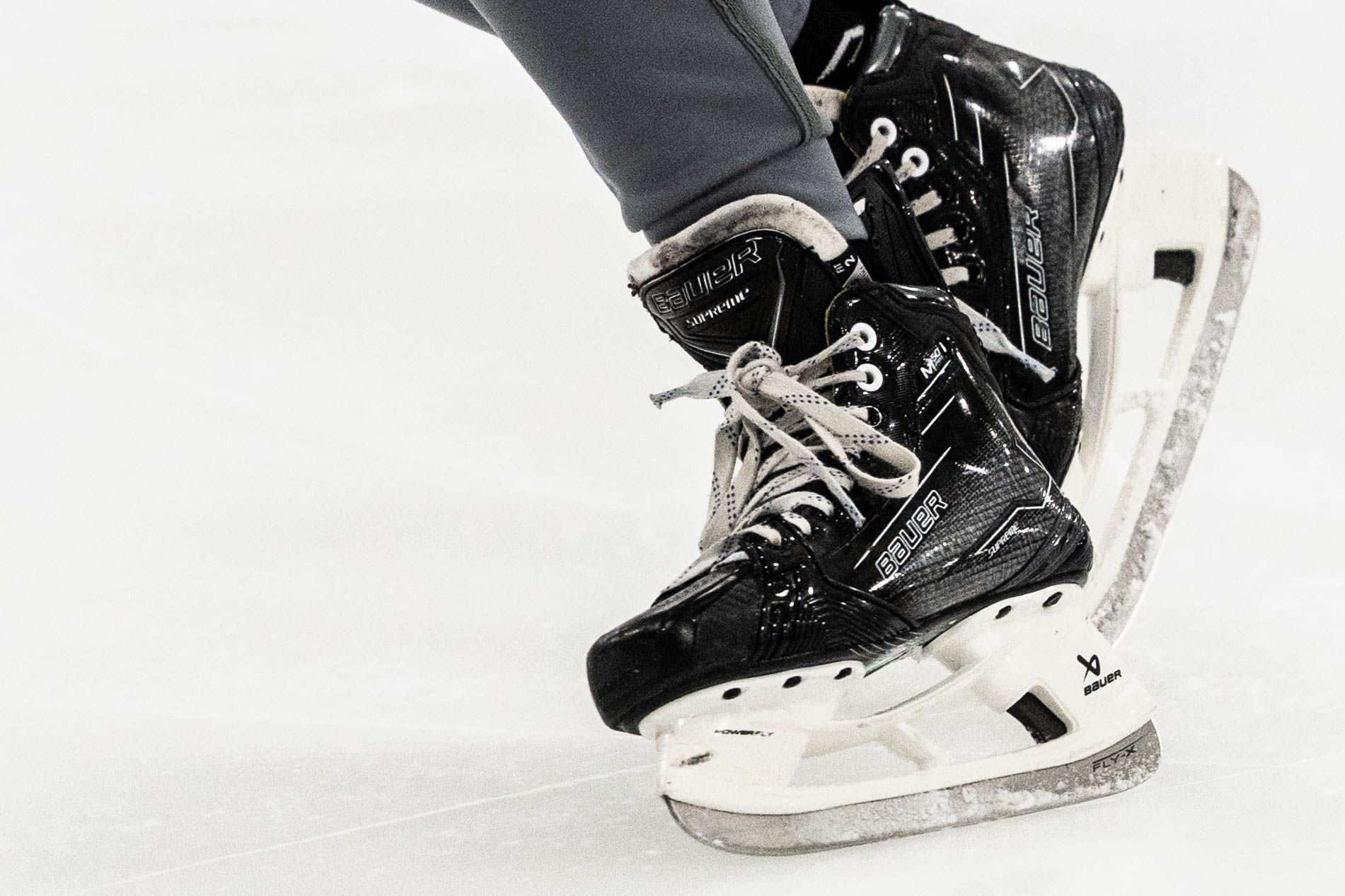 Close-up of hockey skates on the ice